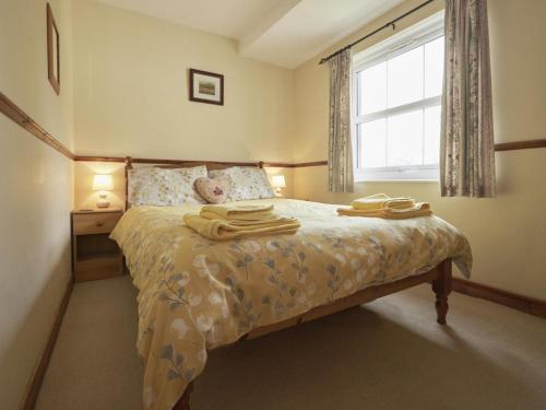1 dormitorio con 1 cama con toallas en 2 Bed in Wasdale SZ551, en Nether Wasdale