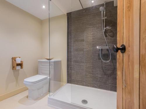 a bathroom with a toilet and a glass shower at 2 Bed in Ravenstonedale SZ141 in Ravenstonedale