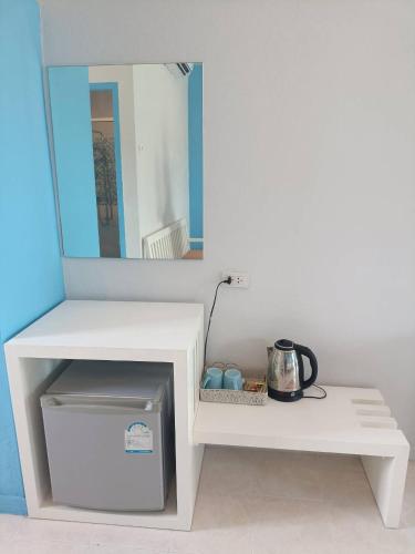 a white shelf with a mirror on top of it at March Samui Resort in Mae Nam