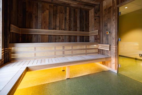 a bench in a room with wooden walls at Serra Boutique Hôtel in Agen