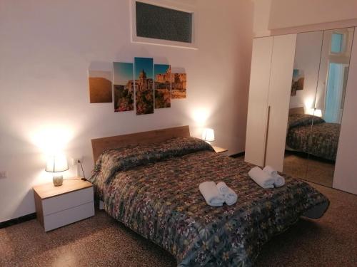 a bedroom with a bed with two white shoes on it at A casa di Vito in Matera