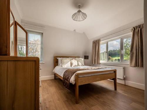a bedroom with a bed and two windows at Pass the Keys Grand country home with space for all the family in Exeter