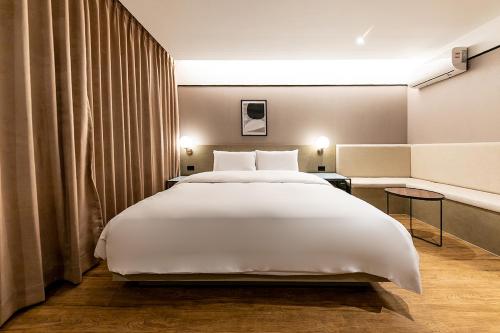 duże białe łóżko w pokoju hotelowym w obiekcie Hotel Yaja Masan Odong Branch w mieście Masan
