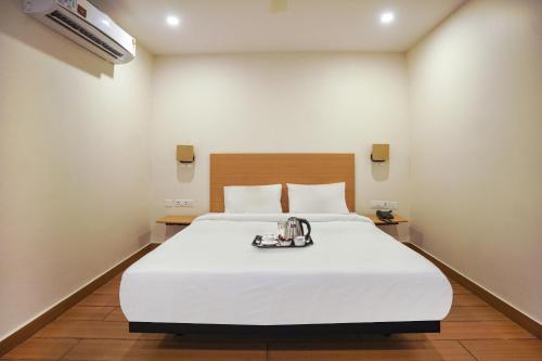 a bedroom with a large white bed in it at Townhouse The Pallagio in Visakhapatnam