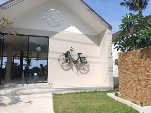 a bike hanging on the side of a house at March Samui Resort in Mae Nam