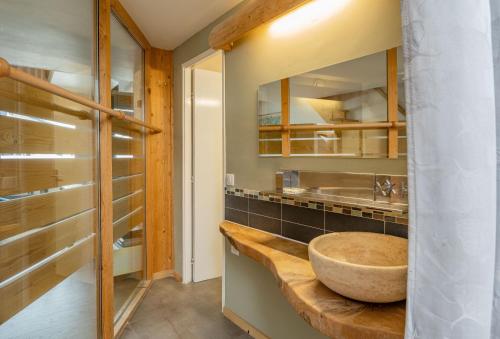 a bathroom with a wooden sink and a mirror at Apartment Genevrier - Spacious Balcony with Mont Blanc Views in Chamonix-Mont-Blanc