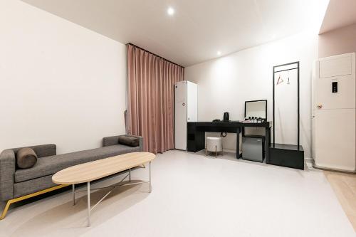 a living room with a couch and a table at Hotel Yaja Masan Odong Branch in Changwon