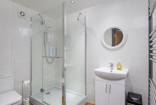 a bathroom with a shower and a sink at Cornerstone Cottage in Laurencekirk