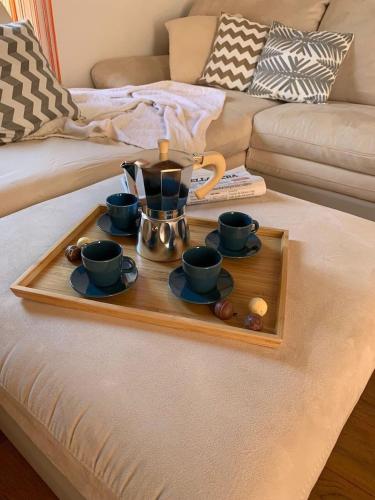 a tray with a tea set on top of a couch at The 4 Senses Experience in Suvereto