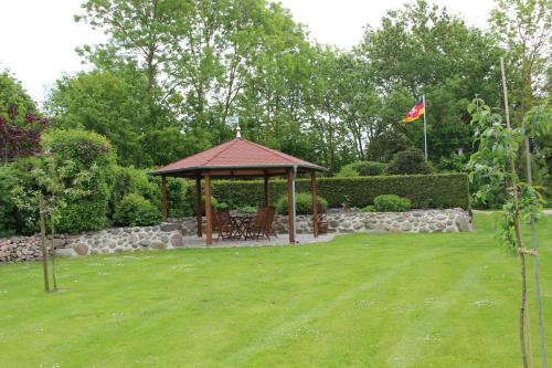 a gazebo with a table and chairs in a yard at Ferienhaus Grambzow in Hohen Demzin