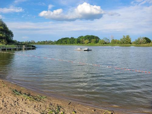 a boat tied to a dock on a lake at Ferienwohnung Teschow in Teschow