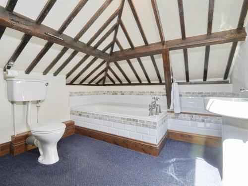 a bathroom with a tub and a toilet and a sink at 1 Bed in Eskdale SZ471 in Beckfoot