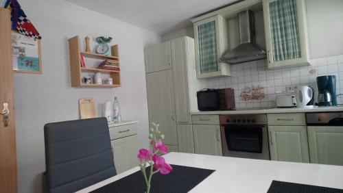 a kitchen with green cabinets and a white counter top at Tetjes Horstel - Ferienwohnung mit Balkon in Teterow