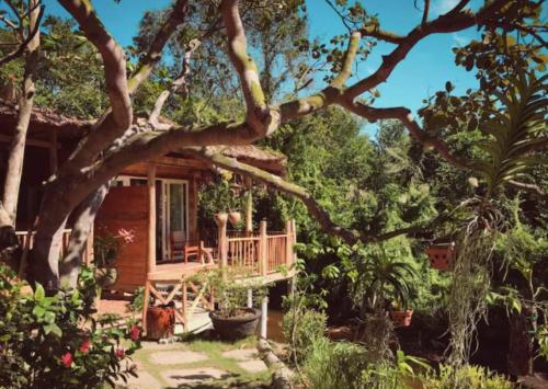 a cabin in the woods with a tree at Bamboo Cottages in Phu Quoc