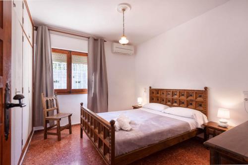 a bedroom with a bed with a stuffed animal on it at Villa Sabine - PlusHolidays in Calpe