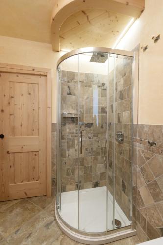 a shower with a glass door in a bathroom at Chalet Roberta in Valdidentro