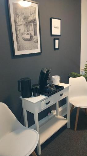 a white table with a coffee maker on it at Bed & Coffee Inn d'n Acht in Venlo