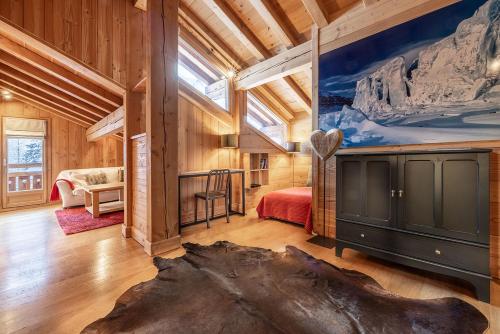 a bedroom with a large window in a wooden house at Chalet La Chaumière in Chamonix