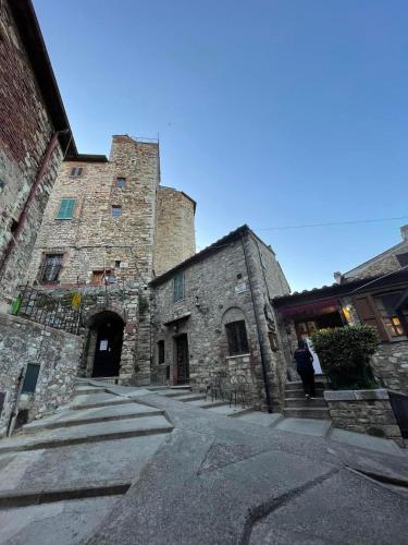 an old stone building with a large tower at The 4 Senses Experience in Suvereto
