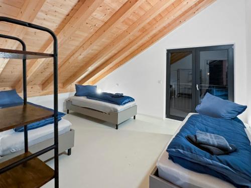 a bedroom with two bunk beds and a wooden ceiling at feworld Freilassing - 2 apartments - near train station - free parking in Freilassing