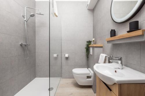 a bathroom with a shower and a toilet and a sink at Molo Longo - Downtown Apartments in Rijeka