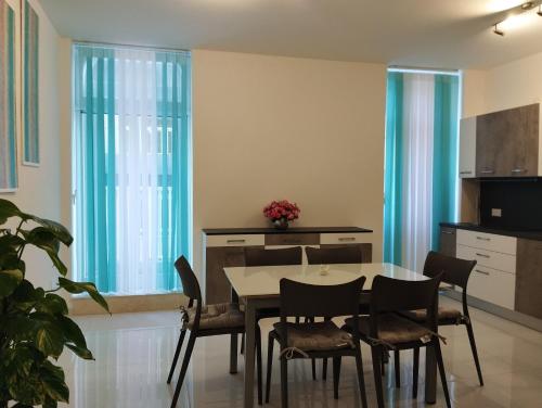 cocina y comedor con mesa y sillas en Pearl Apartments, en Sliema