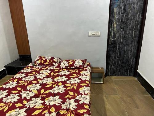 a bedroom with a bed with a floral comforter at The River Side Resort & Farm in Noida