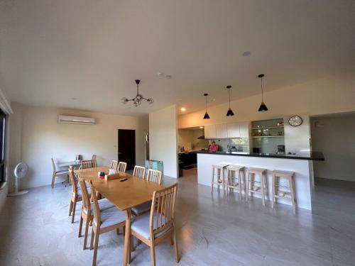 a dining room and kitchen with a table and chairs at Xianyan Villa B&B in Sanyi