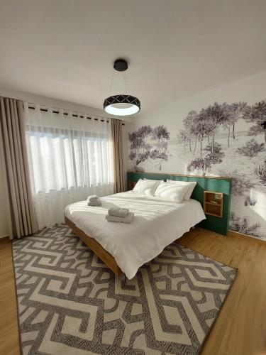 a bedroom with a large bed with a rug at BeHOME in Tirana