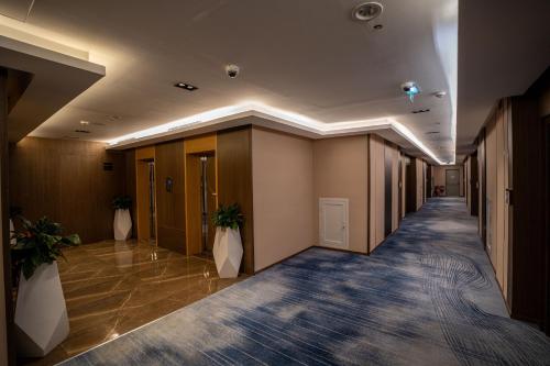 a hallway of an office building with plants at Best Western Plus Danat Almansak Hotel in Abha