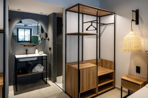 a bathroom with a sink and a mirror at Aparthotel Casita Blanca - Adults Only in San Antonio