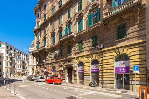 a red car is parked in front of a building at Molo Longo - Downtown Apartments in Rijeka