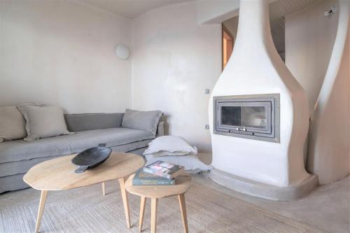 a living room with a couch and a fireplace at Agapitos Villas & Guesthouses in Agios Ioannis Pelio