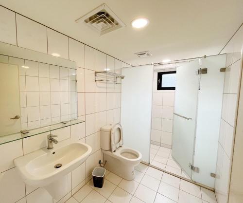 a white bathroom with a sink and a toilet at Xianyan Villa B&B in Sanyi
