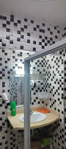 a bathroom with a sink and a mirror at DAR LAAZIZA in Meknès