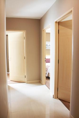 an empty room with two doors and a room with a bed at eL Hotel Jakarta in Jakarta