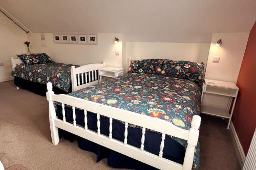 a bedroom with a bed and a crib in it at Into The Burren in Murroogh