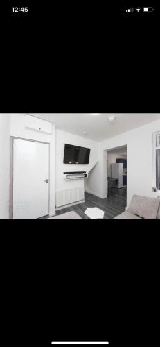 a living room with a bed and a tv at House @ Queens University in Belfast