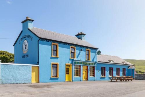a blue building with a bench in front of it at Into The Burren in Murroogh