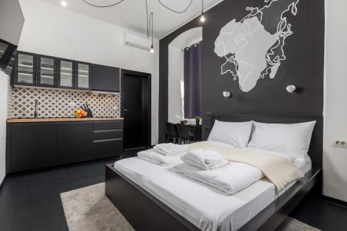 a bedroom with a large bed with a world map on the wall at Molo Longo - Downtown Apartments in Rijeka