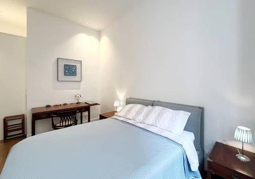 a bedroom with a large bed and a desk at Solemar Sicilia - Palazzo Pirrotta in Palermo