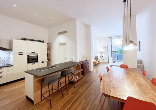 a kitchen with a wooden table and a dining room at Solemar Sicilia - Palazzo Pirrotta in Palermo