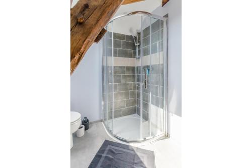 a bathroom with a shower with a glass enclosure at Le saint remeau in Le Jard