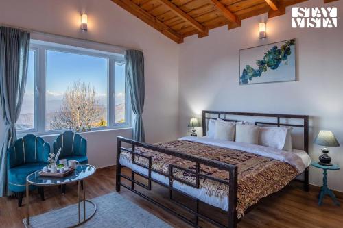 a bedroom with a bed and a large window at StayVista at Alpine Haven - Mukteshwar in Rāmgarh