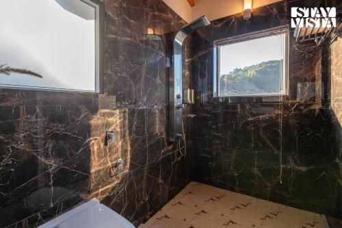 a bathroom with a toilet and a window at StayVista at Alpine Haven - Mukteshwar in Rāmgarh