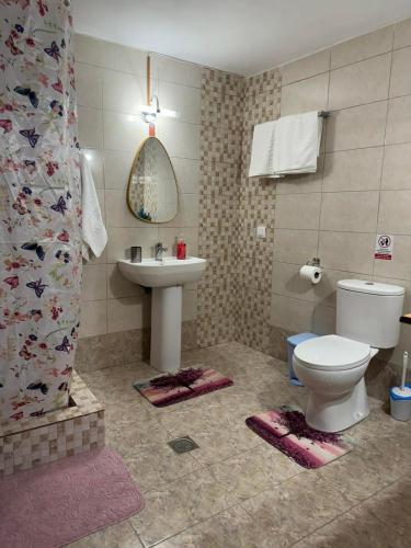 a bathroom with a toilet and a sink at Alleyhouse 83 in Kremasti
