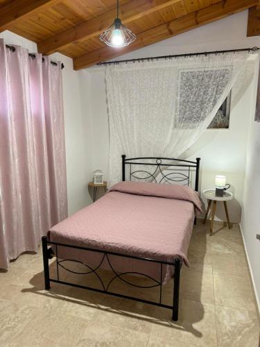 a bedroom with a black bed with a canopy at Alleyhouse 83 in Kremasti