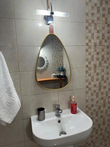 a bathroom with a sink and a mirror at Alleyhouse 83 in Kremasti