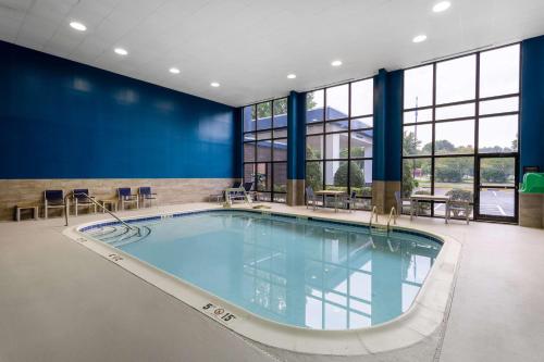 a large swimming pool in a building with windows at Hampton Inn Richmond-SW Hull Street in Midlothian