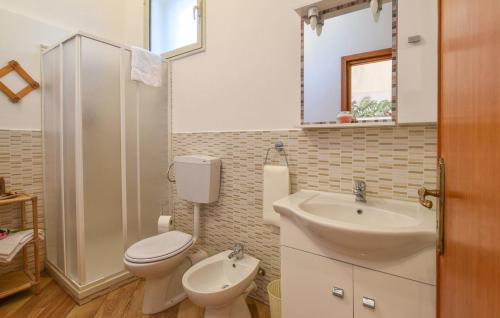 a bathroom with a toilet and a sink at Villa Trappeto in Trappeto